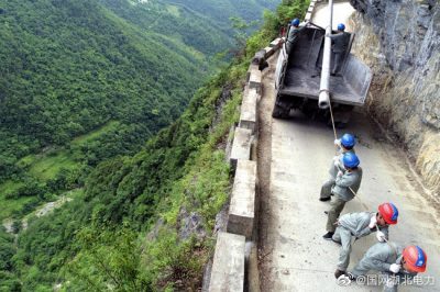 龍坪供電所用人力推車將8米長水泥電桿轉(zhuǎn)運到作業(yè)點